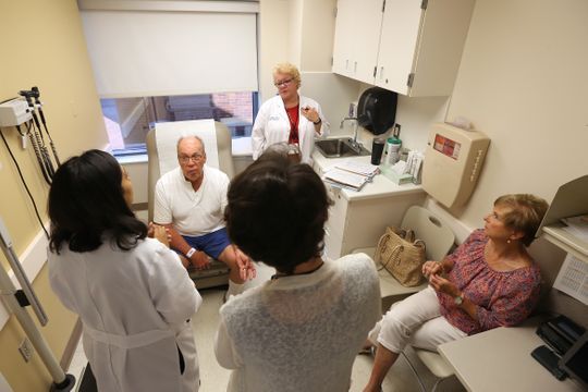 Bob, center, and Elise Rulli, far right, meet with a team of doctors in preparation for Bob's transfusion of the experimental drug BXQ-350, Tuesday, July 10, 2018, at the University of Cincinnati's Barrett Cancer Center in Cincinnati. Rulli of Fort Thomas is Patient No. 1 in a trial for a cancer drug discovered, developed and tested in Greater Cincinnati.